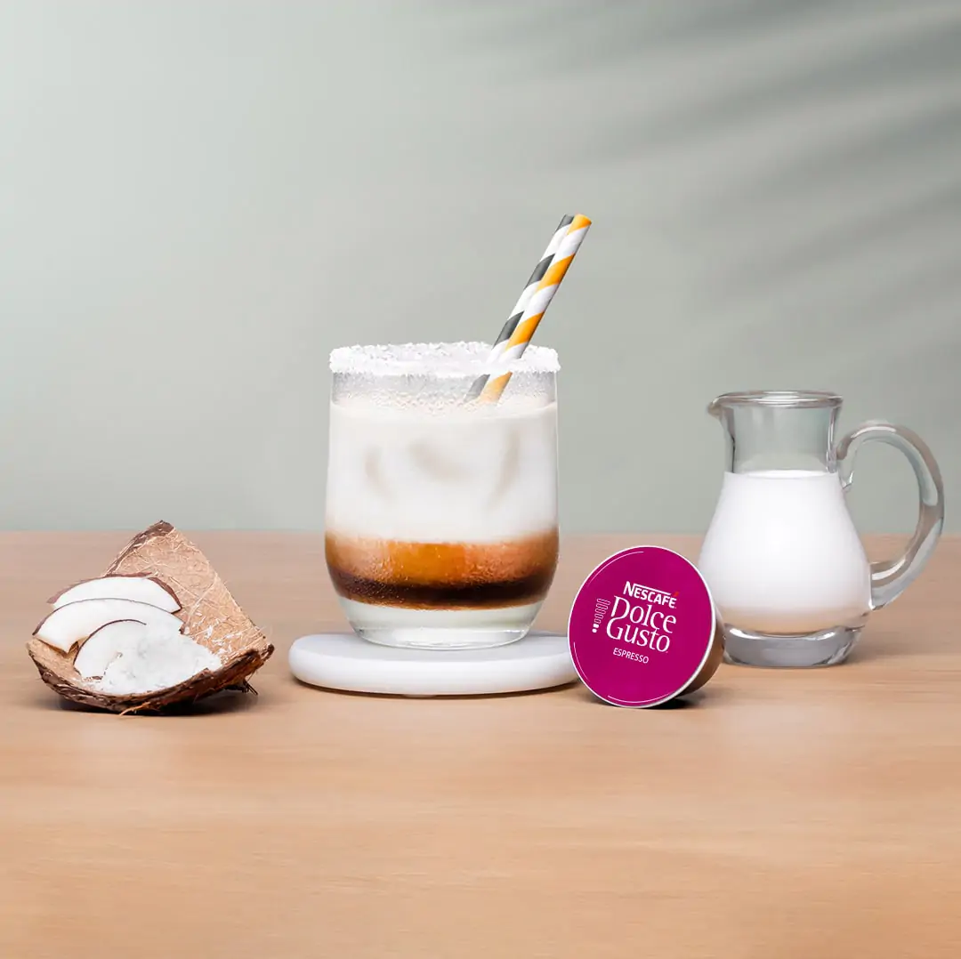 iced espresso next to a coffee capsule